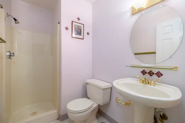 a bathroom with a sink mirror and toilet