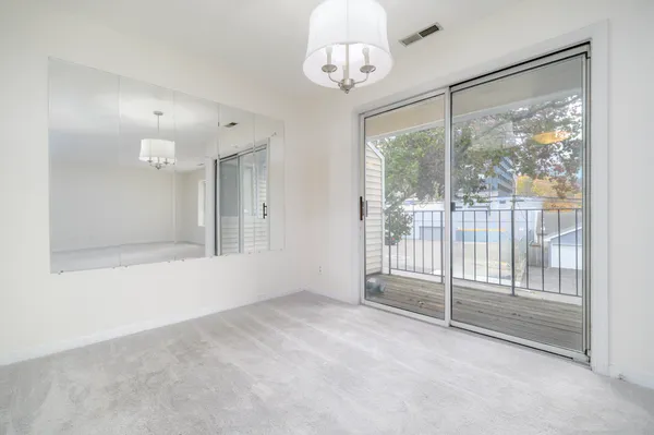 a view of an empty room with a sliding door