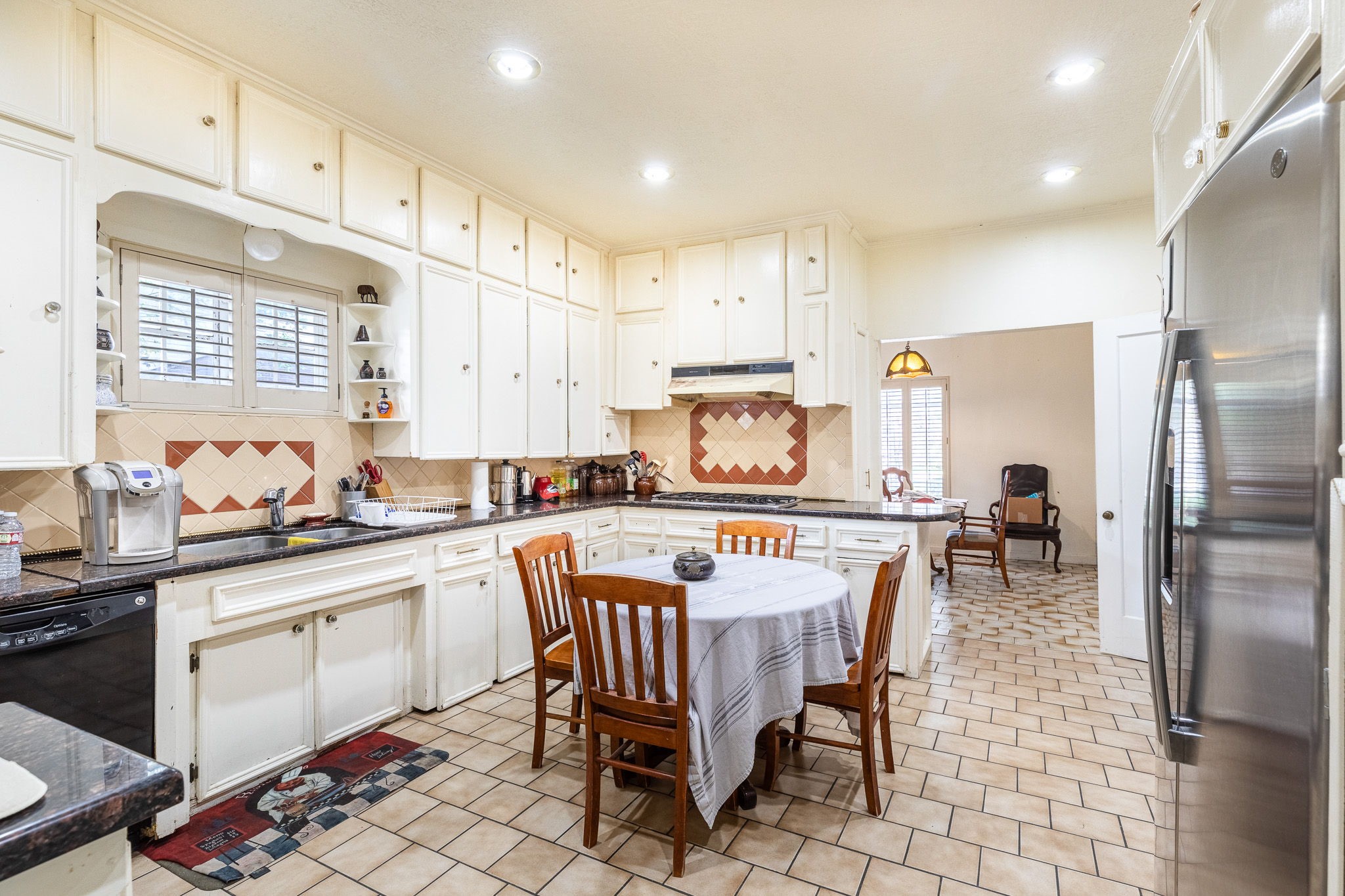 3620 South MacGregor Way Houston, TX 77021 - Photo 4 of 21 a kitchen with stainless steel appliances a white table chairs and a refrigerator