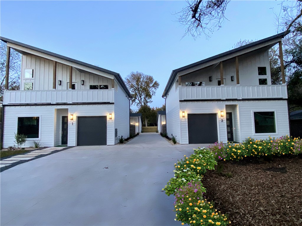 a front view of a house with yard and garage