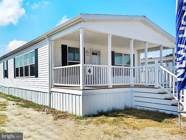 a view of a house with a wooden deck