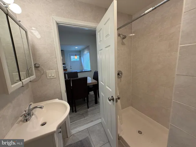 a bathroom with a tub a sink and a mirror