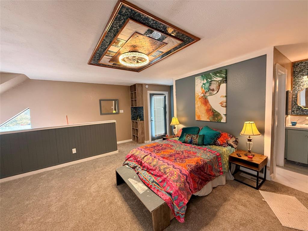 9807 Walnut Street, Unit D205 Dallas, TX 75243 - Photo 14 of 20 a bedroom with a bed and wooden floor