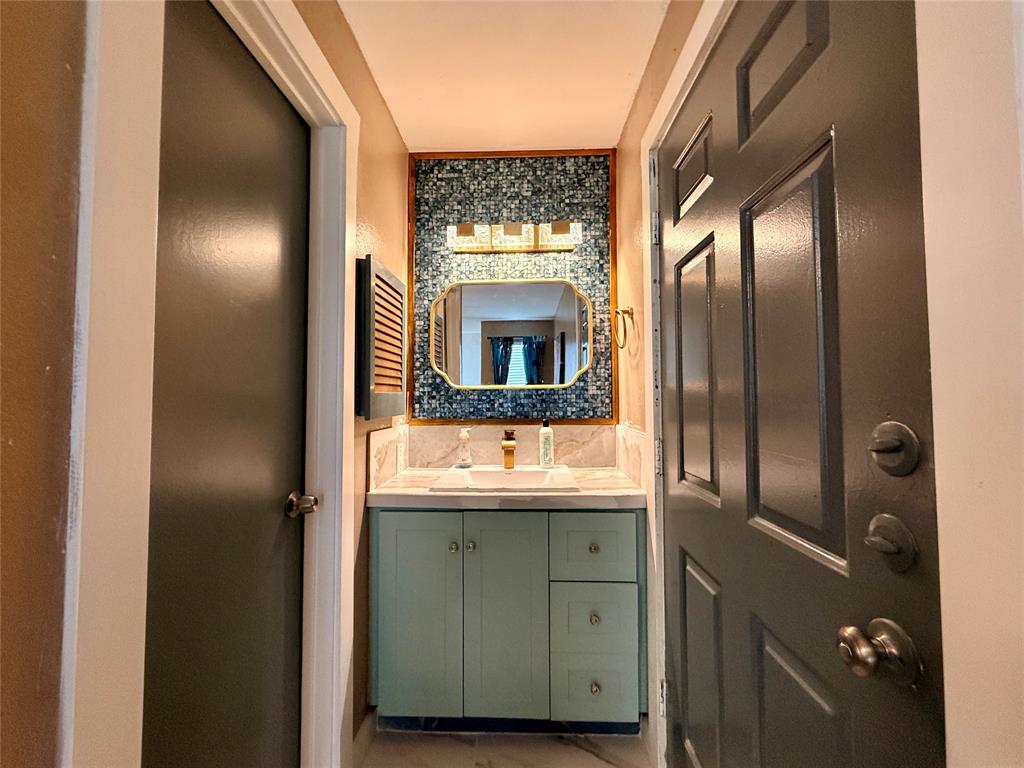 9807 Walnut Street, Unit D205 Dallas, TX 75243 - Photo 15 of 20 a bathroom with a sink and a mirror