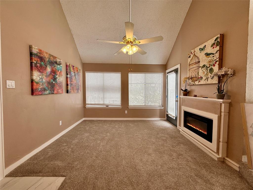 9807 Walnut Street, Unit D205 Dallas, TX 75243 - Photo 4 of 20 a view of an empty room with a fireplace and a window