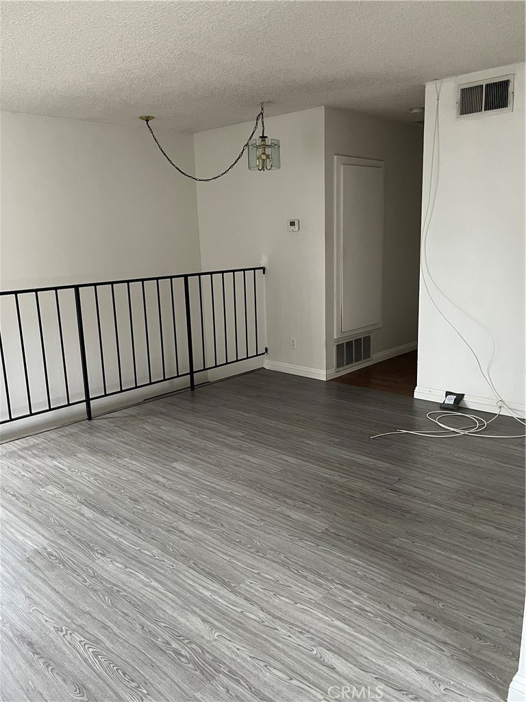 3073 Gladstone Street, Unit 4 Pomona, CA 91767 - Photo 6 of 10 a view of a hallway with wooden floor