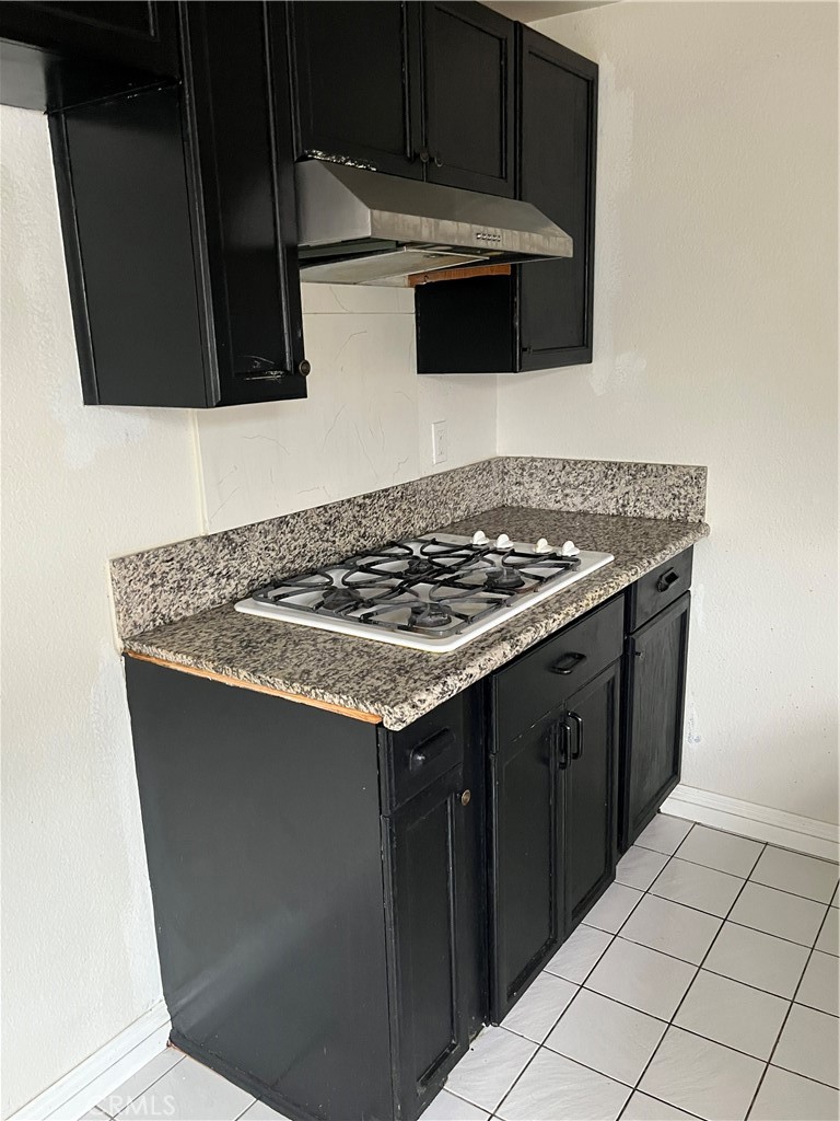 3073 Gladstone Street, Unit 4 Pomona, CA 91767 - Photo 7 of 10 a kitchen with granite countertop a sink and a stove