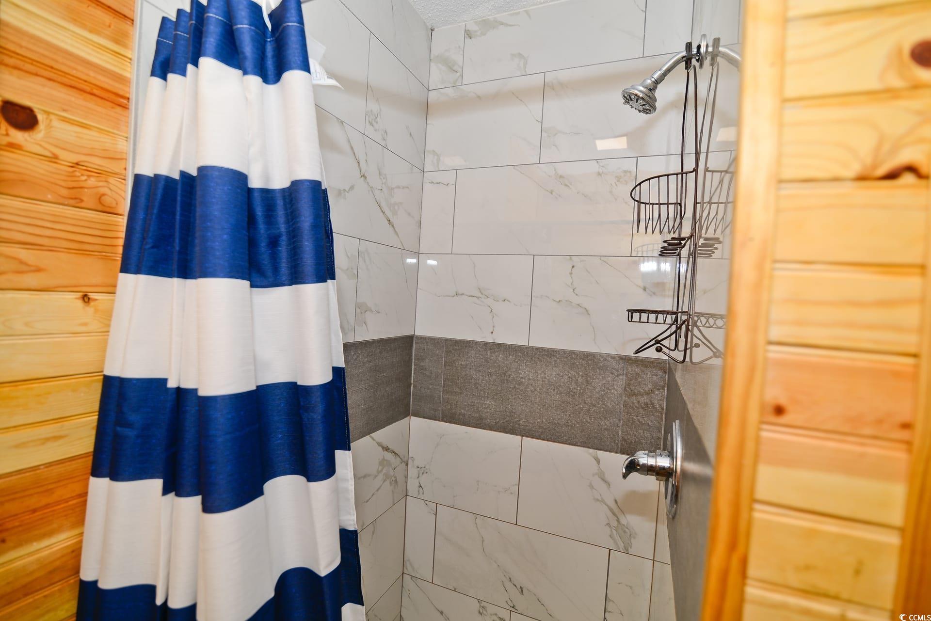 219 27th Avenue North North Myrtle Beach, SC 29582 - Photo 26 of 34 Full bathroom with a tile shower