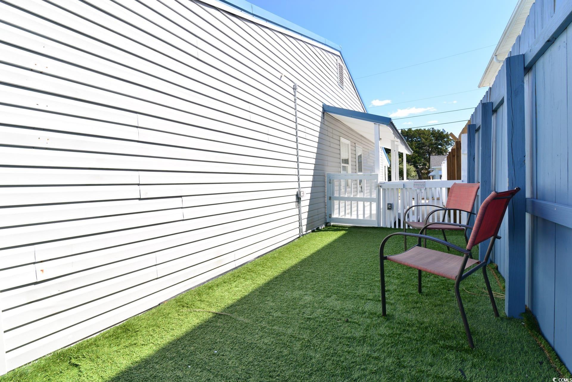 219 27th Avenue North North Myrtle Beach, SC 29582 - Photo 34 of 34 View of side of home with a lawn