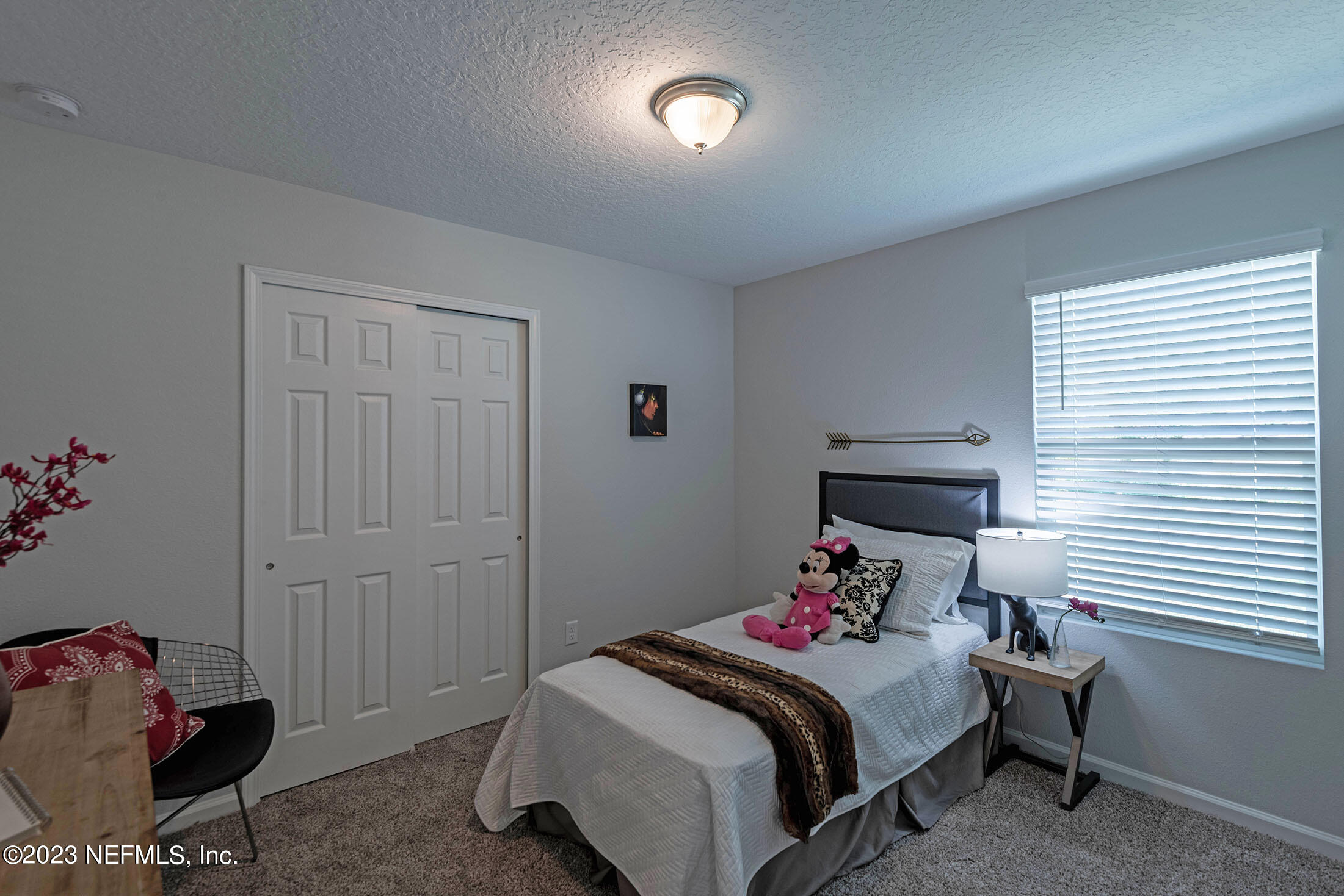 7298 Wheat Road Jacksonville, FL 32244 - Photo 32 of 40 a bedroom with a bed and a window