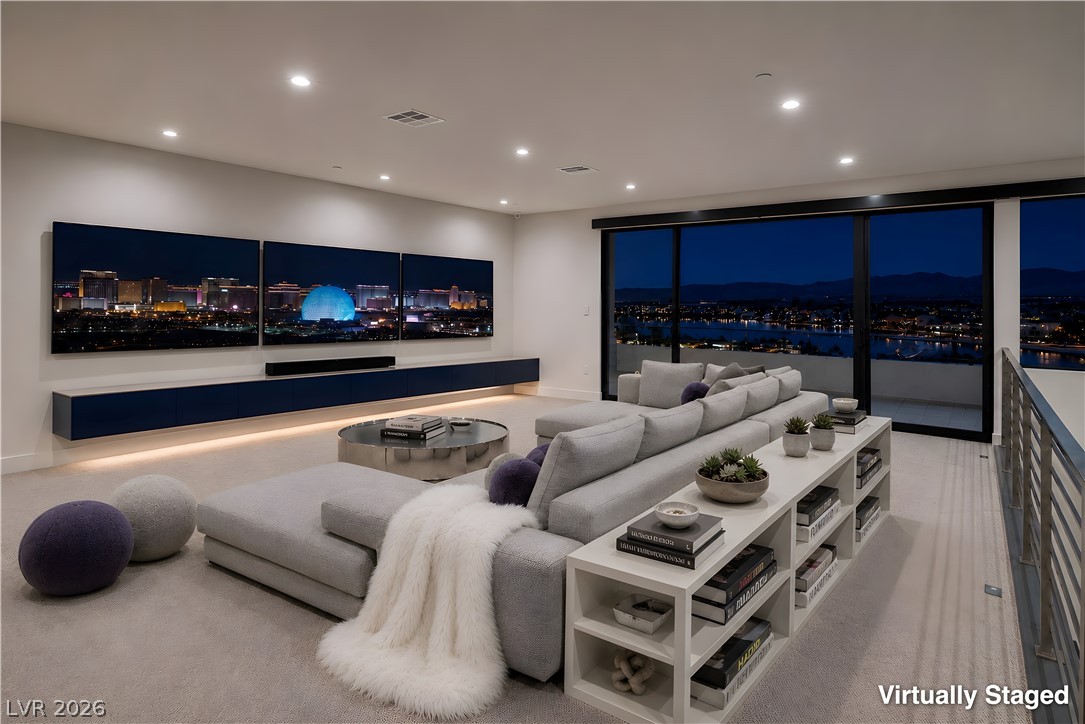25 Falling Ridge Lane Henderson, NV 89011 - Photo 23 of 48 An inviting entertainment space with panoramic night views of the city, perfect for relaxation or hosting.