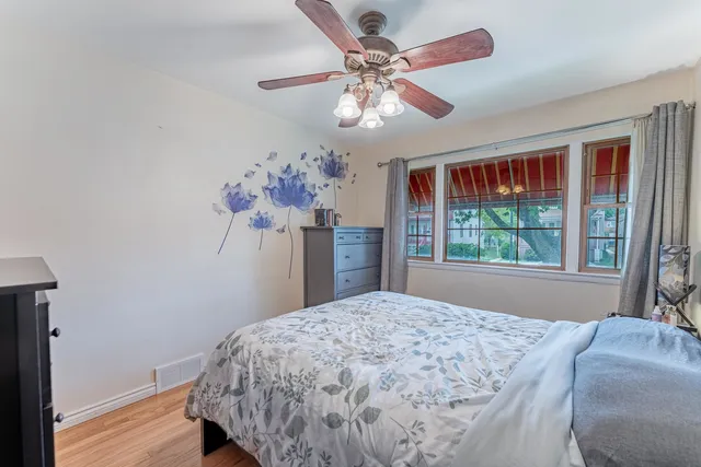 a bed sitting in a bedroom next to a window