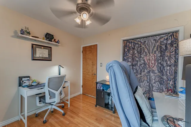 a view of a workspace with furniture and a window
