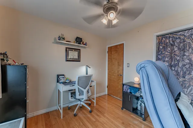 a view of a workspace with furniture and wooden floor
