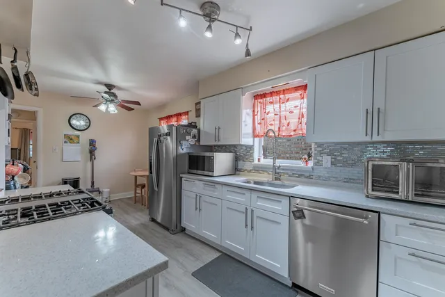 a kitchen with a sink stove and refrigerator