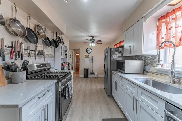 a kitchen with stainless steel appliances granite countertop a sink and cabinets
