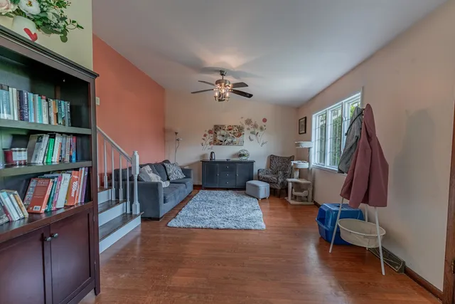 a living room with fireplace furniture and a book shelf