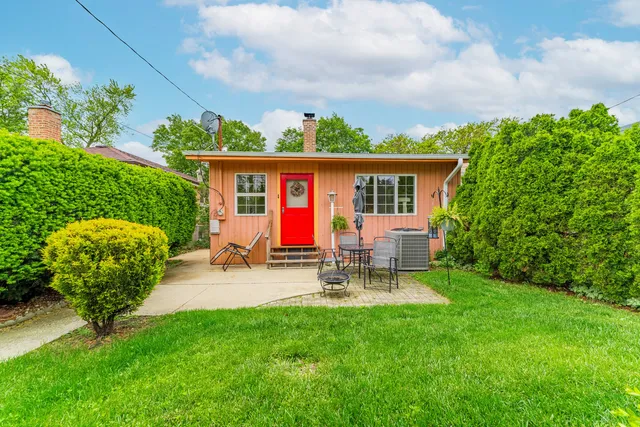 a view of a house with patio and garden