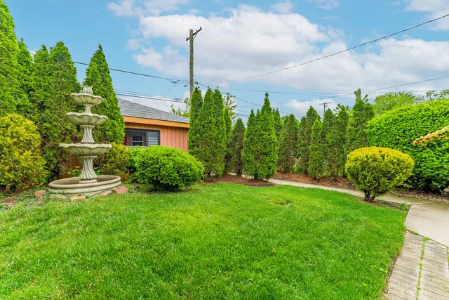 a view of a garden with a table and chairs
