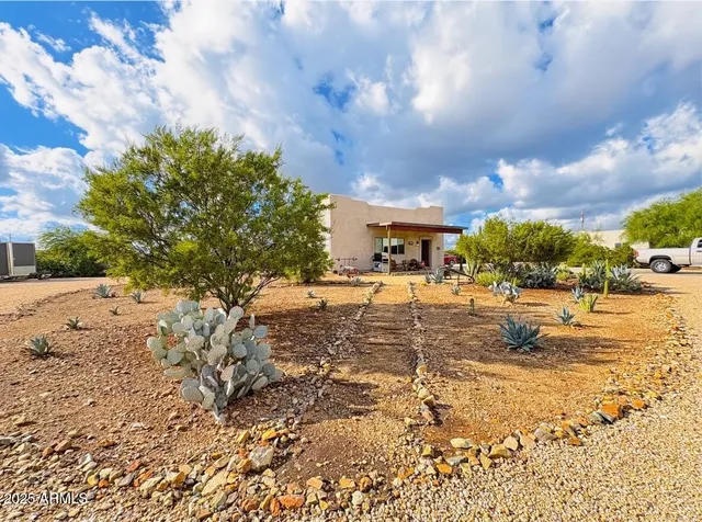 a view of a house with backyard and sitting area