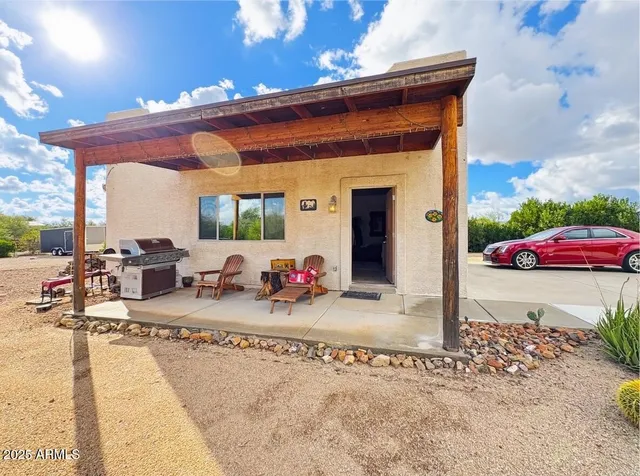 a view of a chairs and a table in the patio