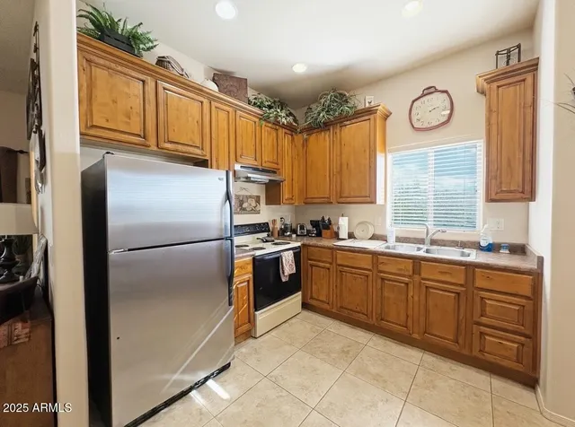a kitchen with a table chairs refrigerator and microwave