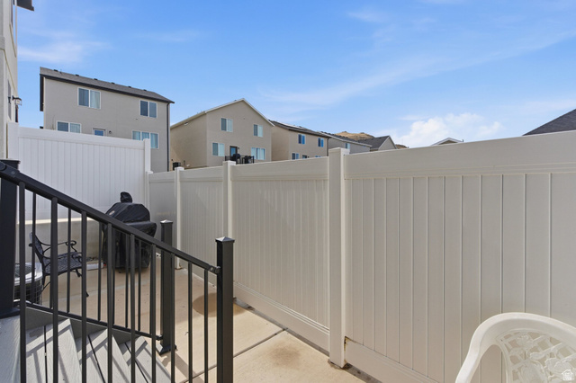 3808 Galatia Road Magna, UT 84044 - Photo 39 of 59 Private outdoor patio space featuring concrete flooring, white vinyl fencing, and black metal railings
