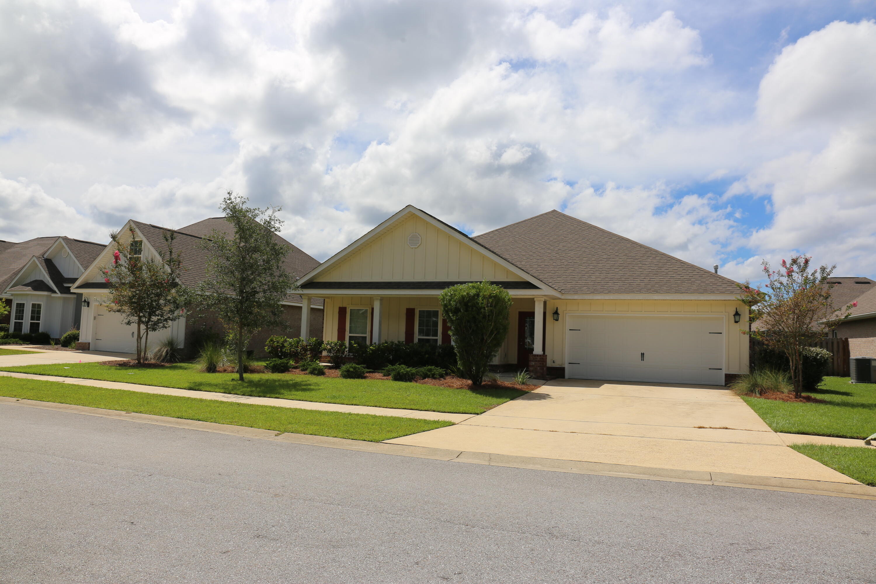 400 Lilly Bell Lane, Unit LOT 26 Freeport, FL 32439 - Photo 1 of 43 a front view of a house with a yard and trees