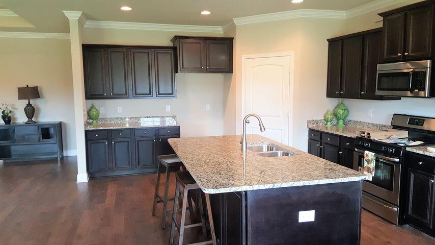 400 Lilly Bell Lane, Unit LOT 26 Freeport, FL 32439 - Photo 17 of 43 a kitchen with stainless steel appliances granite countertop a sink a stove a microwave a refrigerator and cabinets