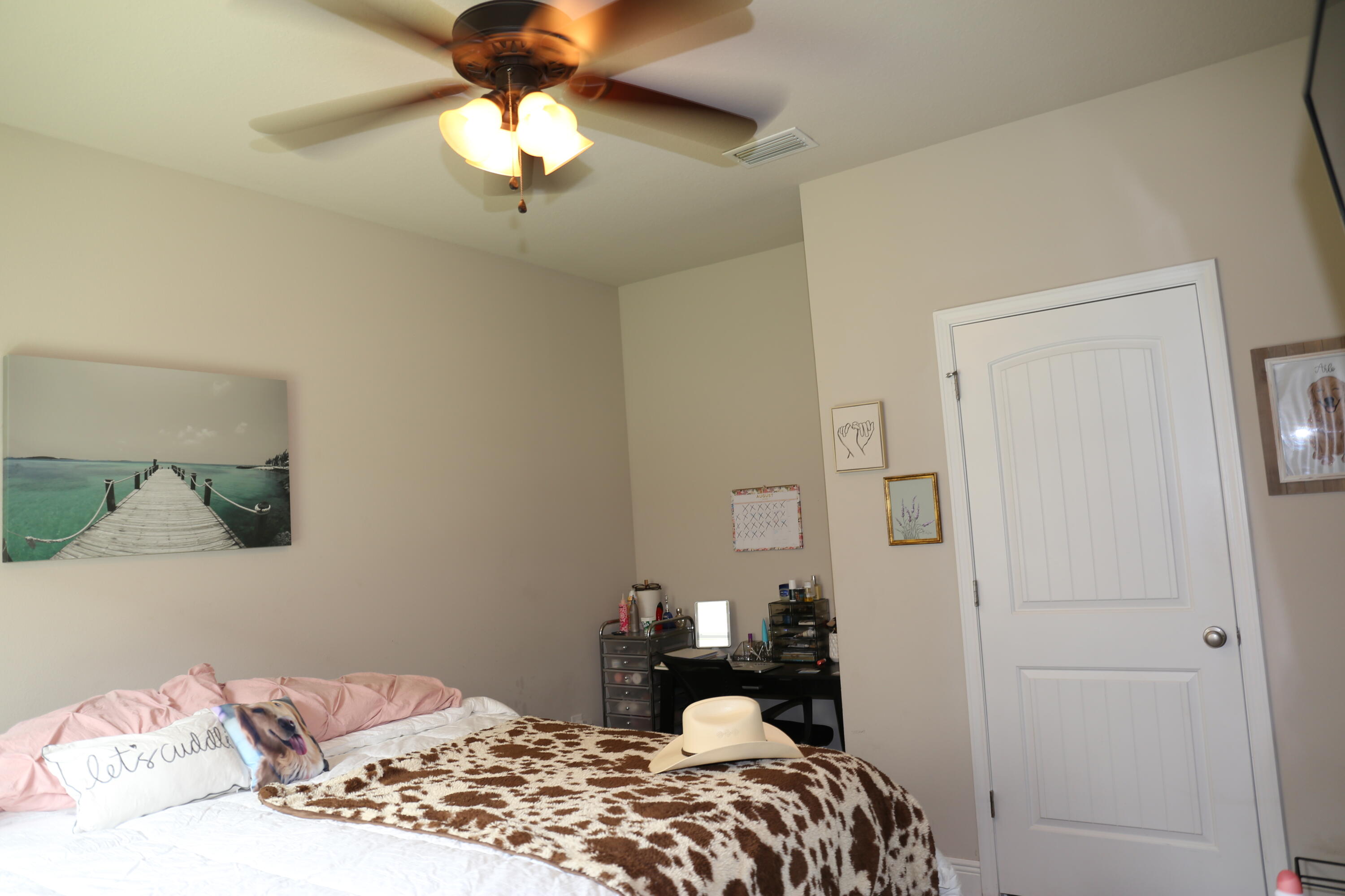 400 Lilly Bell Lane, Unit LOT 26 Freeport, FL 32439 - Photo 23 of 43 a bedroom with a bed and a chandelier
