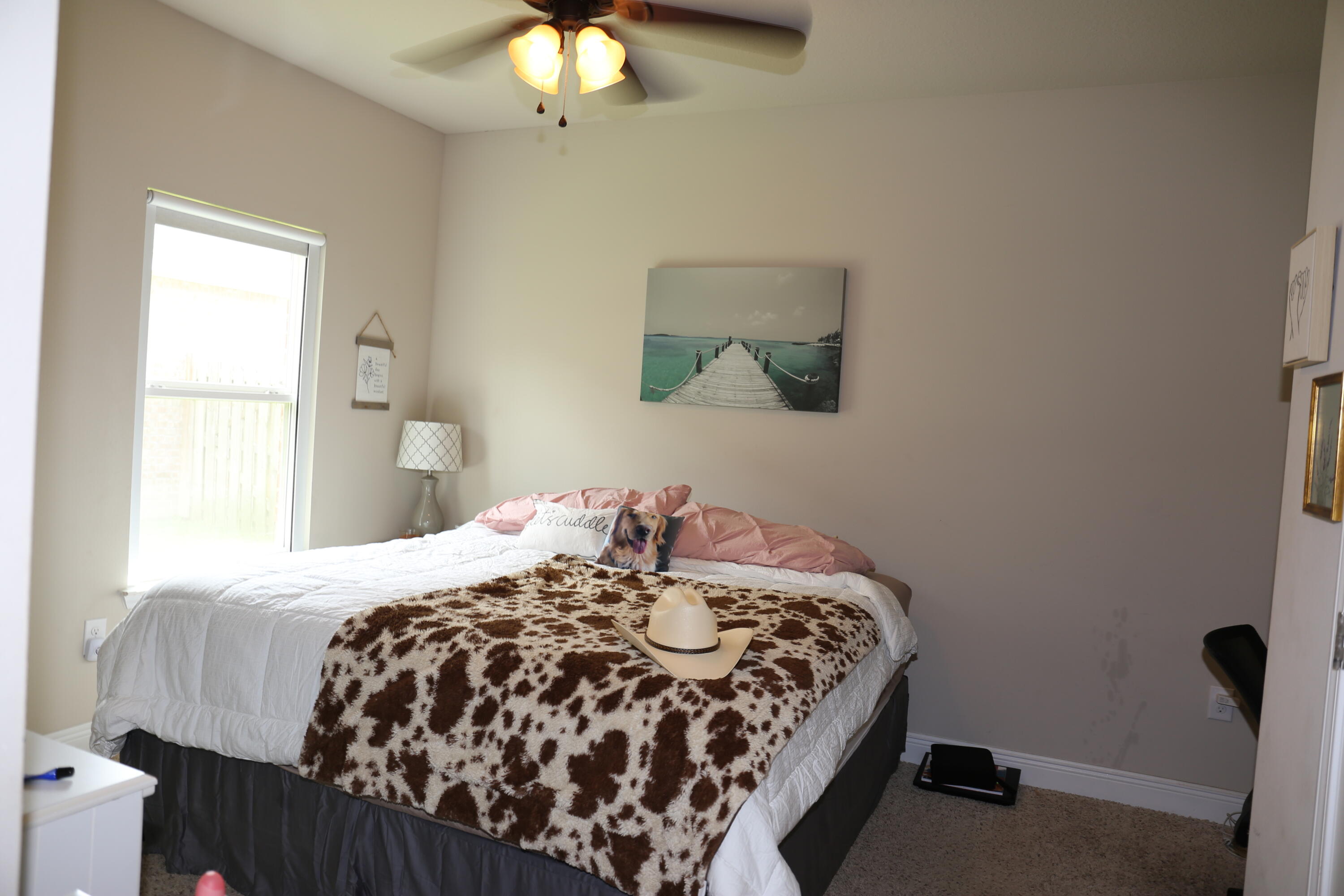 400 Lilly Bell Lane, Unit LOT 26 Freeport, FL 32439 - Photo 24 of 43 a bedroom with a bed and a chandelier