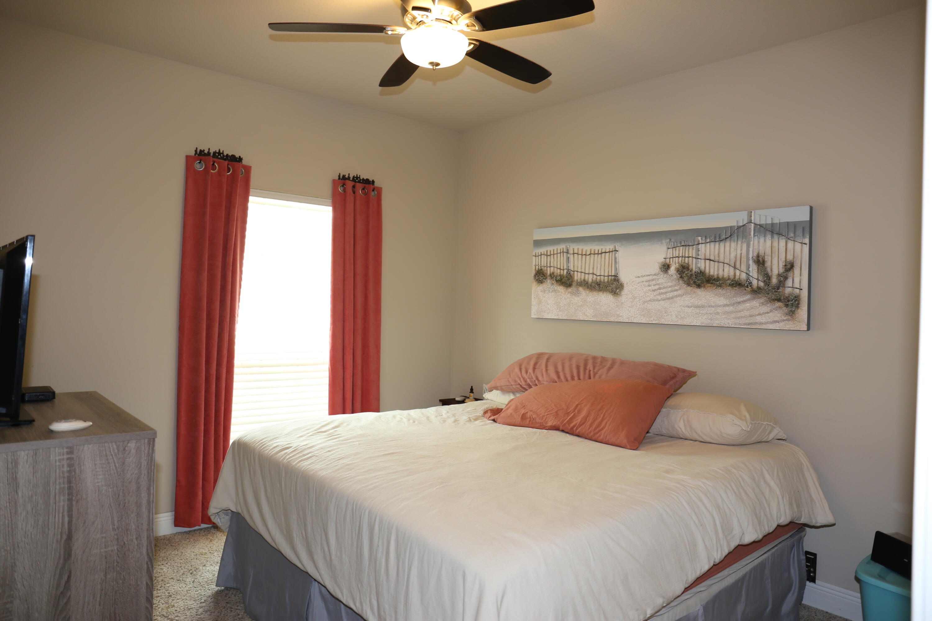 400 Lilly Bell Lane, Unit LOT 26 Freeport, FL 32439 - Photo 26 of 43 a bedroom with a large bed and a flat tv screen