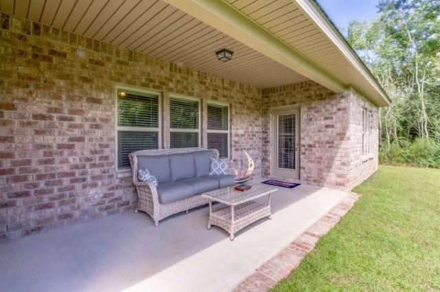 400 Lilly Bell Lane, Unit LOT 26 Freeport, FL 32439 - Photo 29 of 43 a view of a house with backyard and a patio