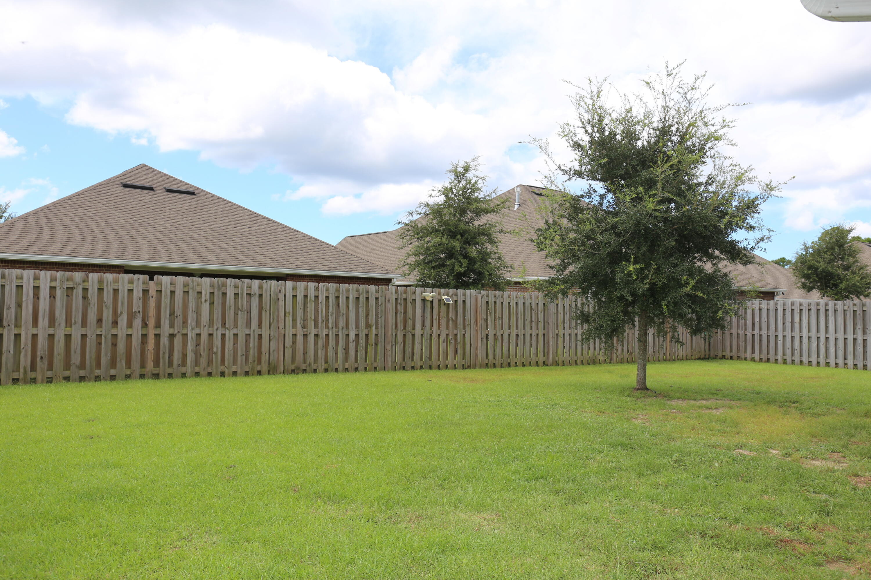 400 Lilly Bell Lane, Unit LOT 26 Freeport, FL 32439 - Photo 31 of 43 a view of a backyard with a fence