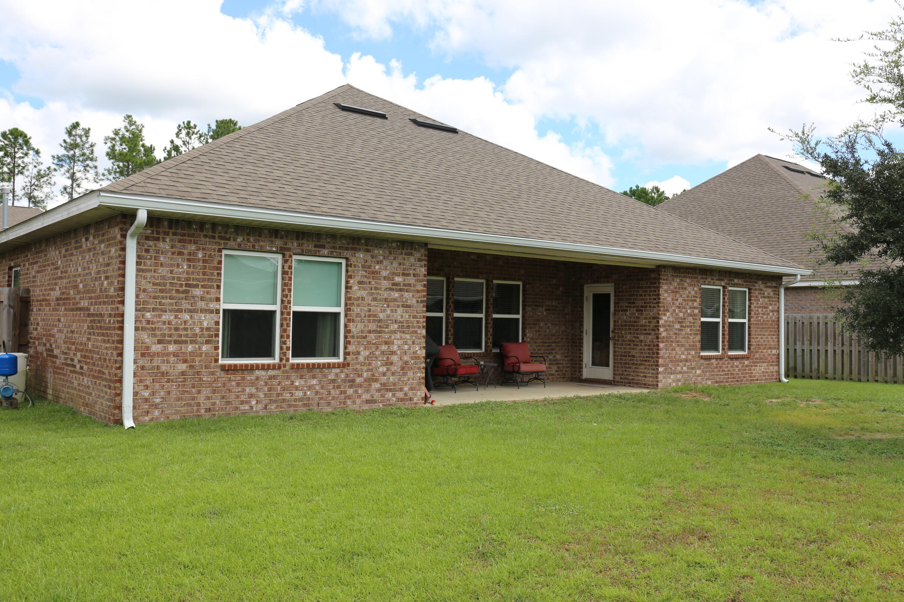 400 Lilly Bell Lane, Unit LOT 26 Freeport, FL 32439 - Photo 35 of 43 a front view of a house with a garden and yard