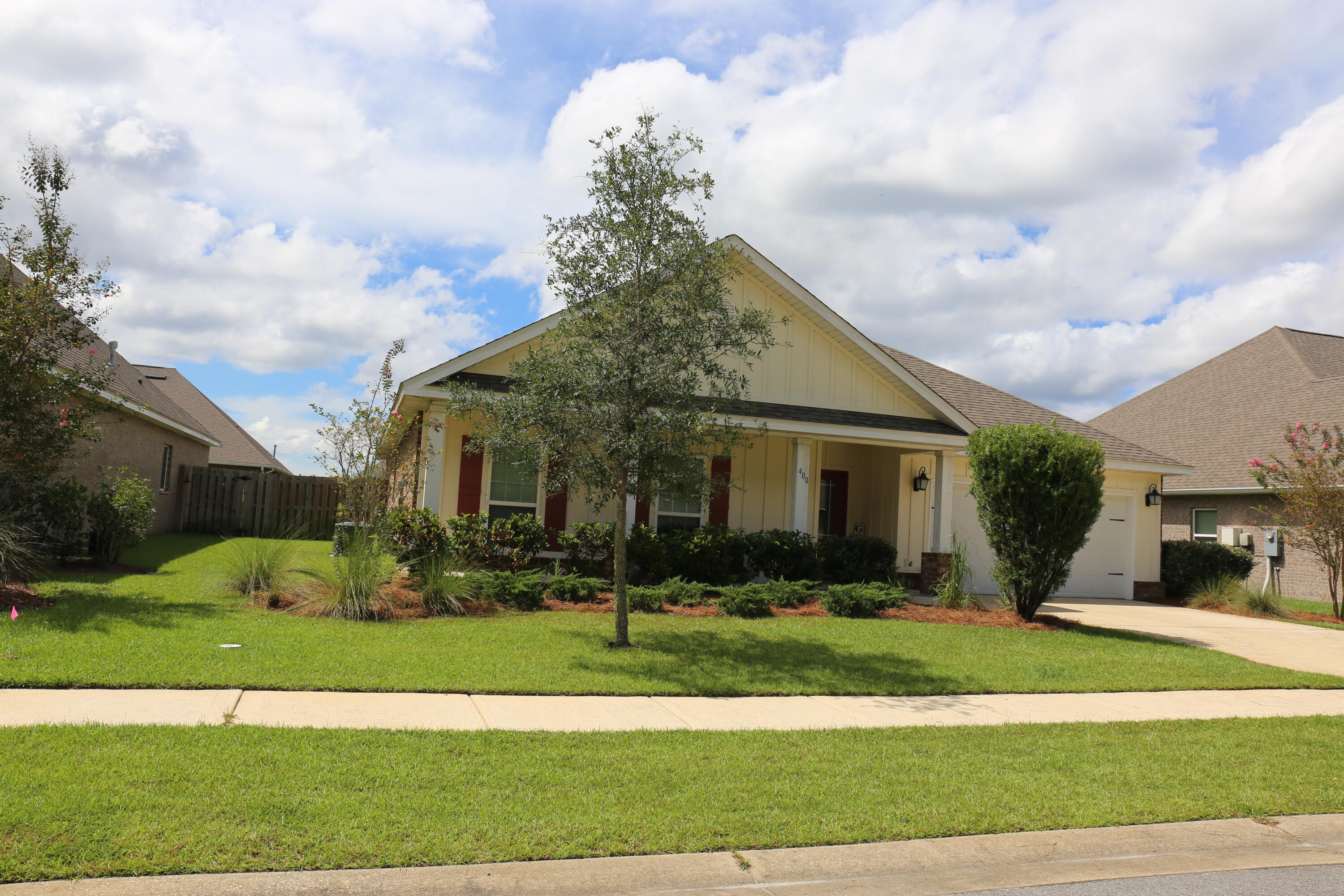 400 Lilly Bell Lane, Unit LOT 26 Freeport, FL 32439 - Photo 4 of 43 a front view of a house with garden