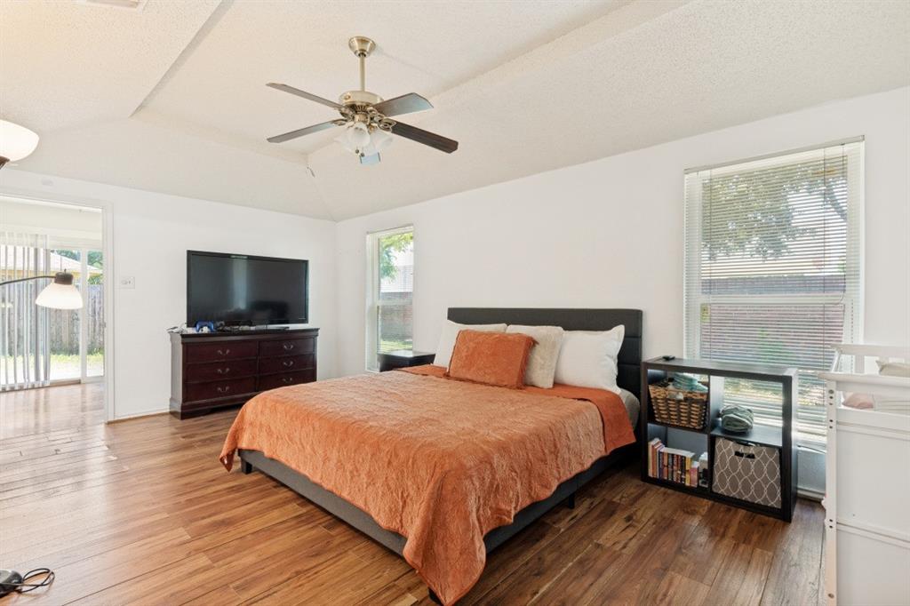 7410 Jessica Way Rowlett, TX 75088 - Photo 21 of 25 a bedroom with a bed and a flat screen tv