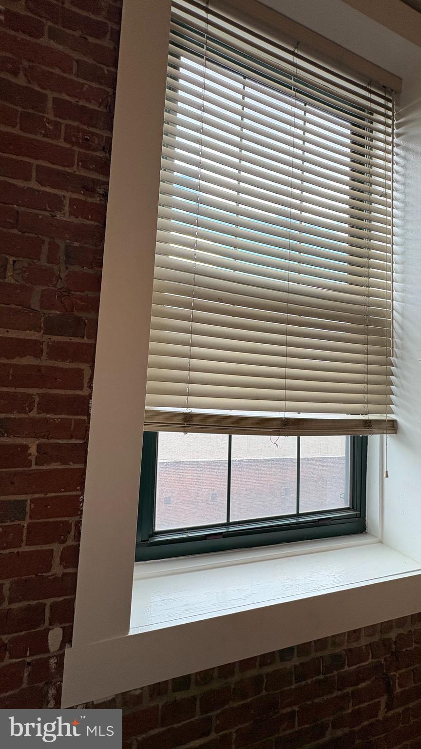 1010 Race Street, Unit 5I Philadelphia, PA 19107 - Photo 3 of 11 a view of a brick wall with windows