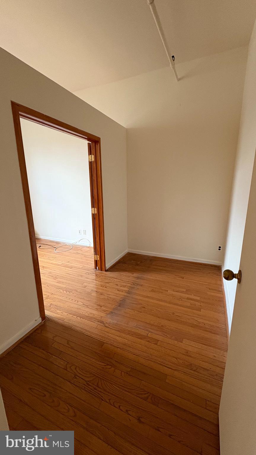 1010 Race Street, Unit 5I Philadelphia, PA 19107 - Photo 7 of 11 a view of an empty room with wooden floor and a window