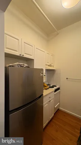 a kitchen with a refrigerator and a stove
