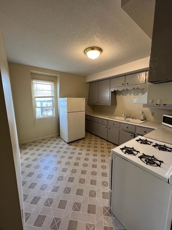 153 Jencks Street Fall River, MA 02723 - Photo 8 of 19 a kitchen that has a sink and a stove