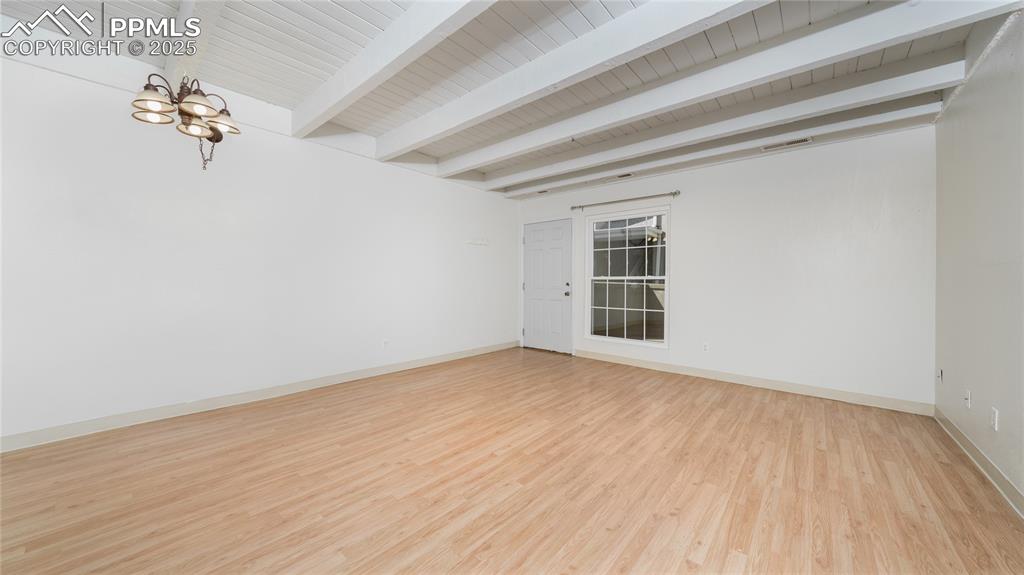 3150 Van Teylingen Drive, Unit A Colorado Springs, CO 80917 - Photo 3 of 14 a view of an empty room with wooden floor and a window