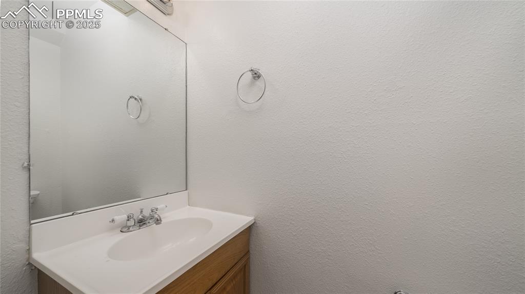3150 Van Teylingen Drive, Unit A Colorado Springs, CO 80917 - Photo 7 of 14 a bathroom with a sink and mirror