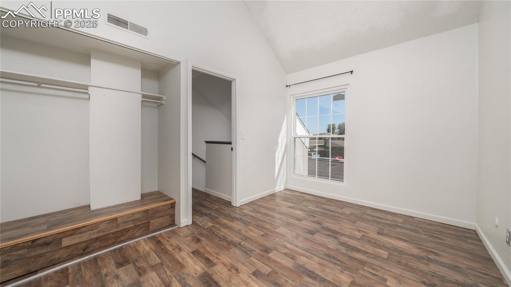 3150 Van Teylingen Drive, Unit A Colorado Springs, CO 80917 - Photo 8 of 14 a view of an empty room with wooden floor and a window