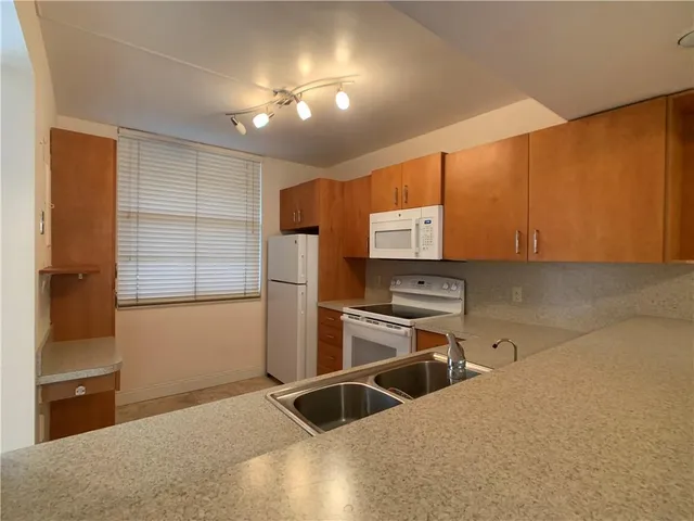 a kitchen with a refrigerator and a sink