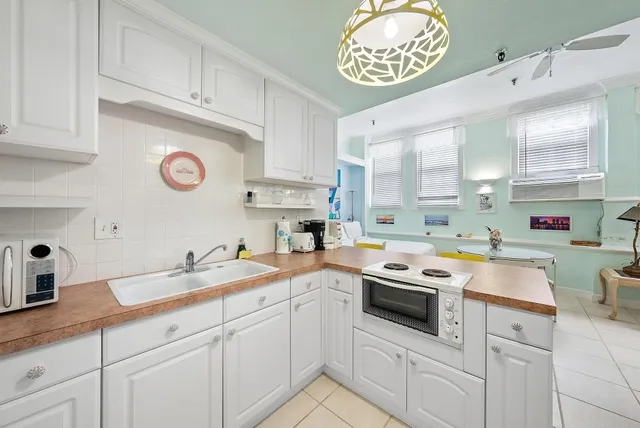 a kitchen with cabinets appliances and a sink