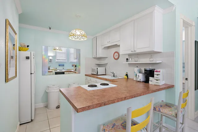 a kitchen with a sink a stove cabinets and counter space
