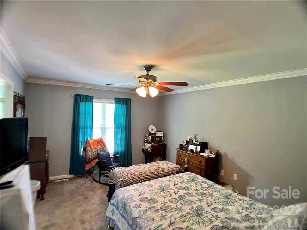 2325 Sides Road Rockwell, NC 28138 - Photo 12 of 14 a bedroom with a bed and a chandelier