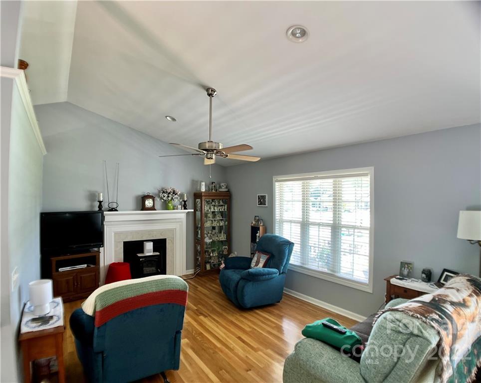2325 Sides Road Rockwell, NC 28138 - Photo 7 of 14 a living room with furniture a flat screen tv and a fireplace