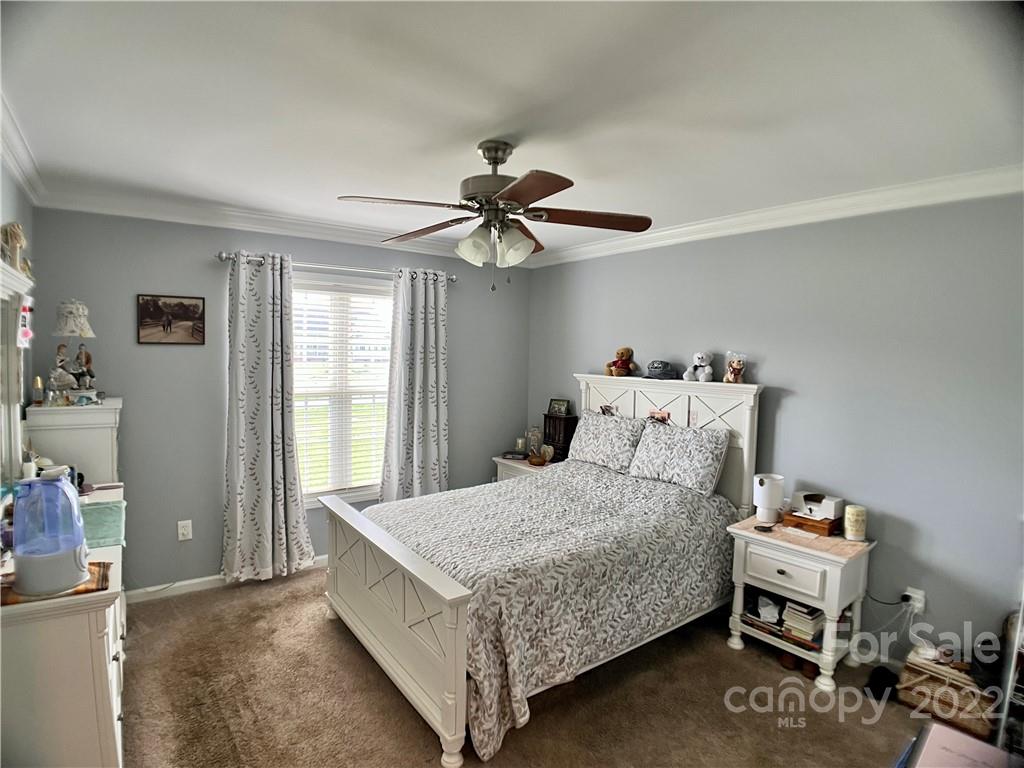 2325 Sides Road Rockwell, NC 28138 - Photo 10 of 14 a bedroom with a bed and a chandelier